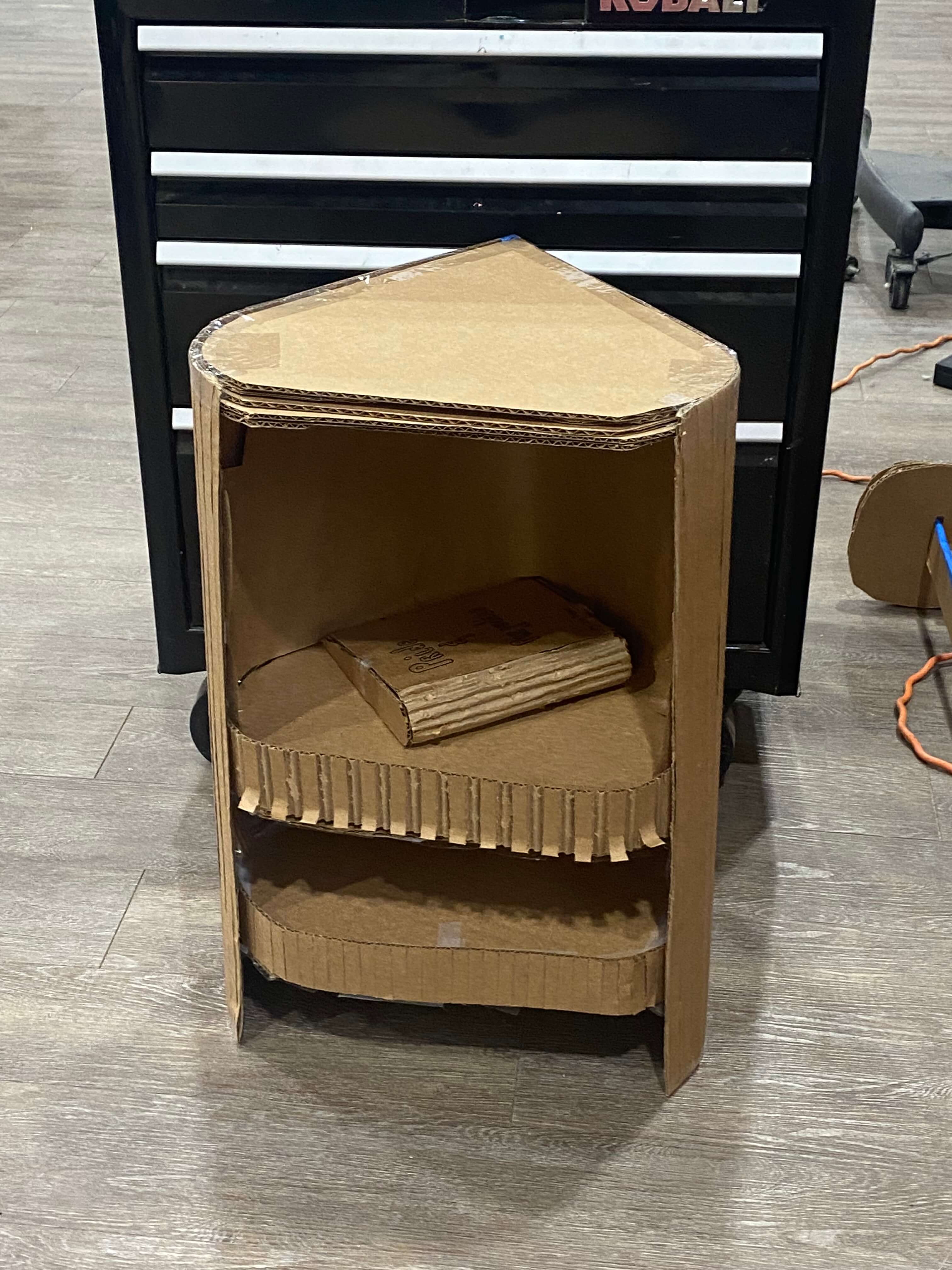 A picture of a bookshelf made of cardboard, front view.